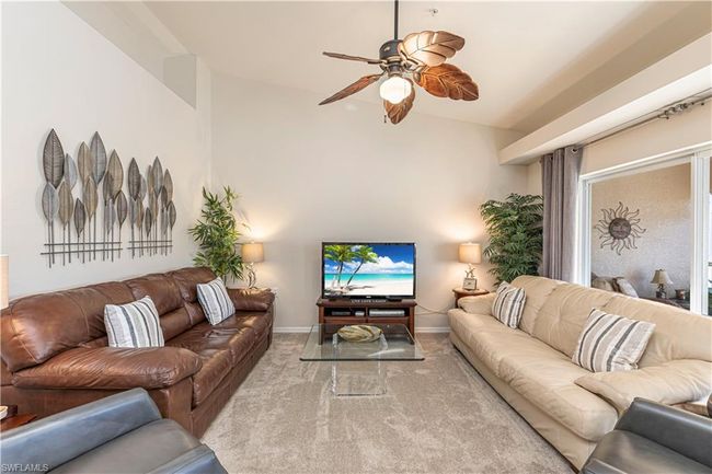 Living room with baseboards, ceiling fan, and carpet | Image 8