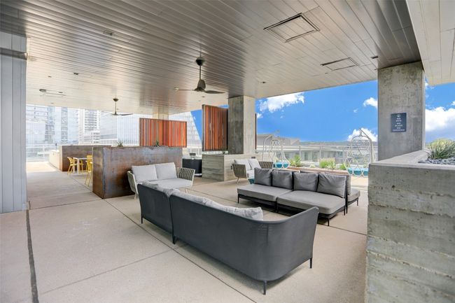 View of patio with outdoor lounge area, ceiling fan, and outdoor dry bar | Image 27