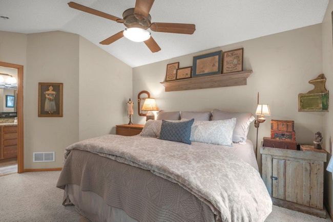 Owner's Suite with vaulted ceiling and adjustable speed ceiling fan! Shelf above the bed will not be staying. Spacious bedroom with a comfortable yet spacious feel. Shutters next to the windows will not stay. | Image 11