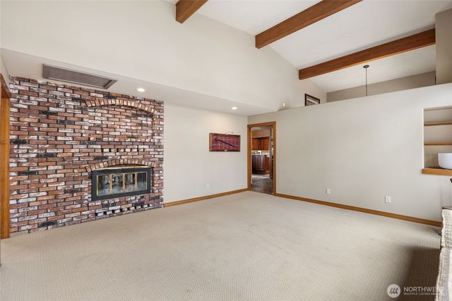 Double sided fireplace and large room for easy entertaining and built in shelves and window seat. | Image 13