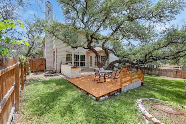 Rear view of house with a deck and a chimney | Image 32
