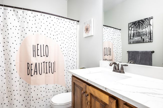 Bathroom with vanity, a shower with curtain, and toilet | Image 21