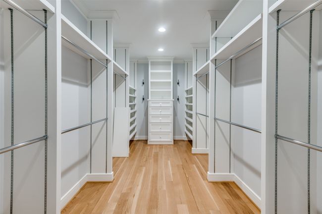Spacious closet with light wood-style floors | Image 15
