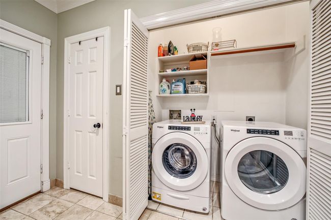 Laundry room area located near the back door (garage entry). | Image 13