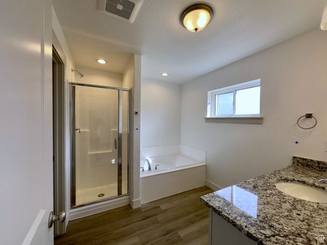 Master Bathroom LVP floors, independent shower and bath, and vanity | Image 9