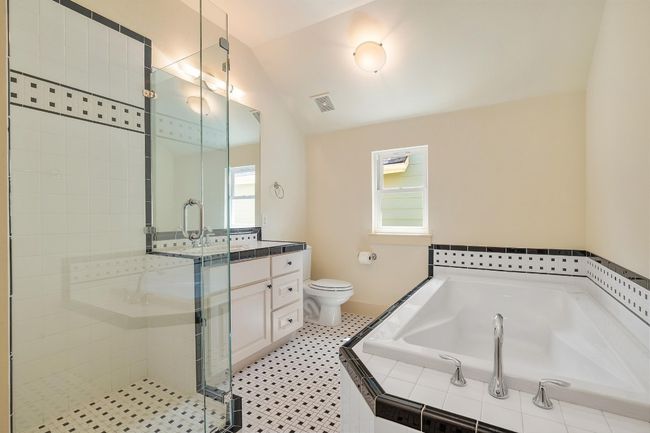 The guest bathroom features soaking tub and walk-in shower | Image 29