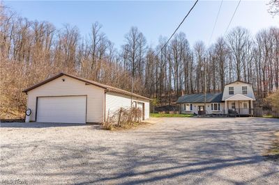 View of front facade featuring a porch and a garage | Image 2