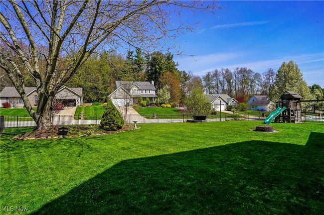 View of yard with fence, a residential view, and a playground | Image 41