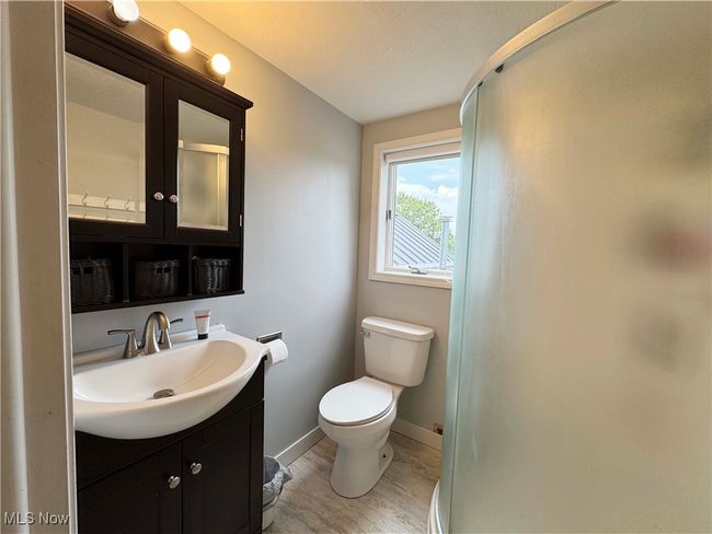 Second floor bathroom with vanity, a shower stall, and wood finished floors | Image 22