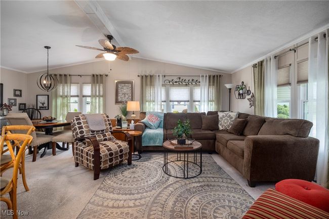 Living area featuring light carpet, a ceiling fan, and ornamental molding | Image 17