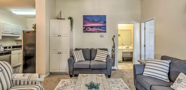 Living area featuring baseboards and light carpet | Image 5