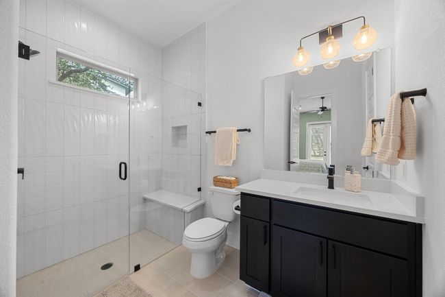 Full bath with healthy amount of natural light, vanity, a shower stall, and tile patterned floors | Image 26