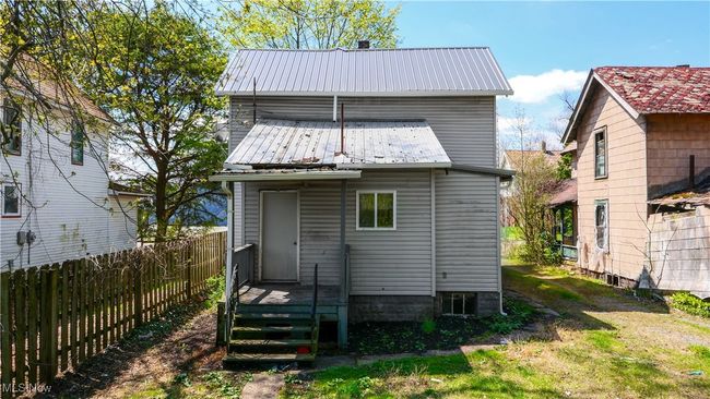 Back of property featuring a metal roof and a deck | Image 20