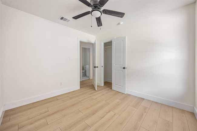 Unfurnished bedroom with light wood-type flooring and a ceiling fan | Image 26