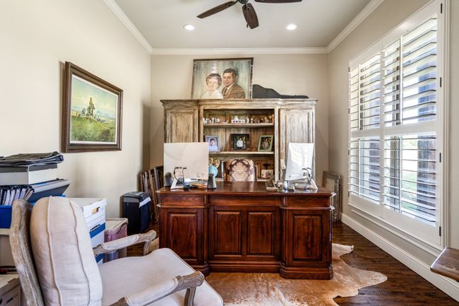 Home office featuring ceiling fan, ornamental molding, dark wood-type flooring, and recessed lighting | Image 10