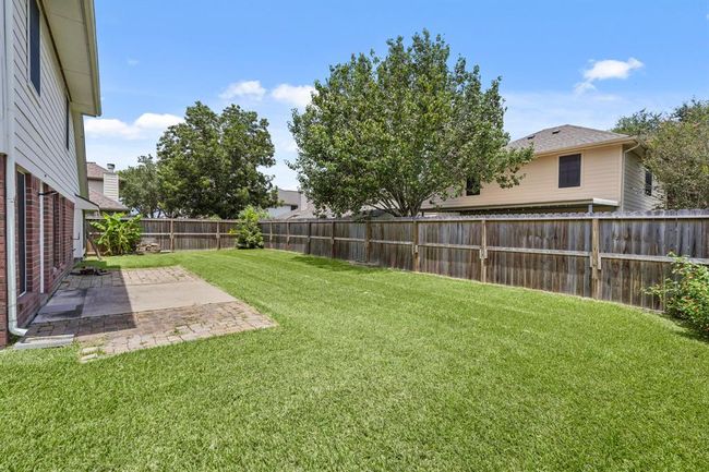 Discover a spacious backyard oasis, perfect for relaxation and outdoor gatherings. | Image 21