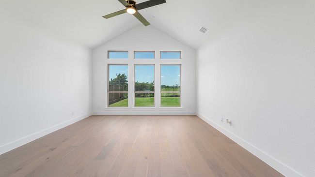 Unfurnished room with baseboards, visible vents, wood finished floors, and a ceiling fan | Image 8
