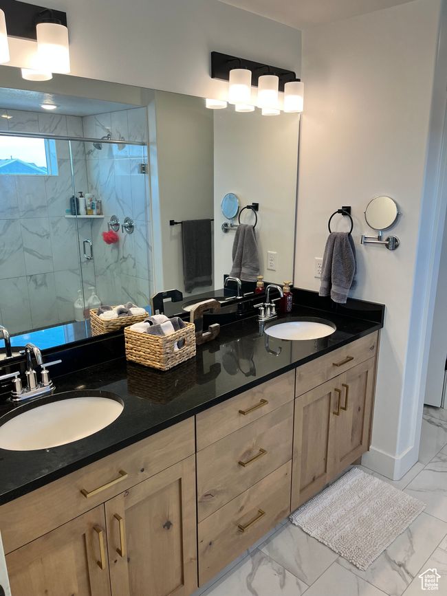 Full bath featuring marble finish flooring, double vanity, and a marble finish shower | Image 15