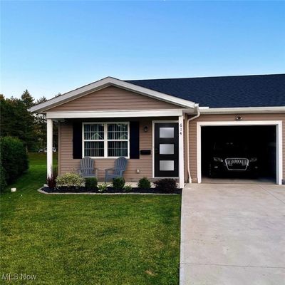 Ranch-style house with a front yard and a garage | Image 2