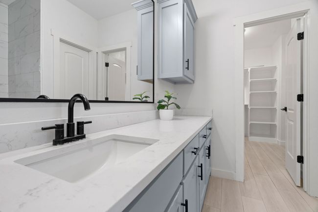 Bathroom featuring vanity and a walk in closet | Image 25
