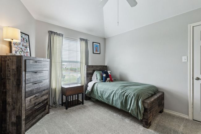 Bedroom with a ceiling fan and light colored carpet | Image 24