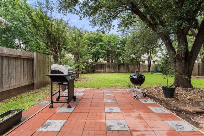 View of patio featuring a playground and grilling area | Image 35