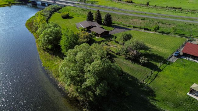 Aerial view of sparsely populated area with a nearby body of water and a notable bridge | Image 48