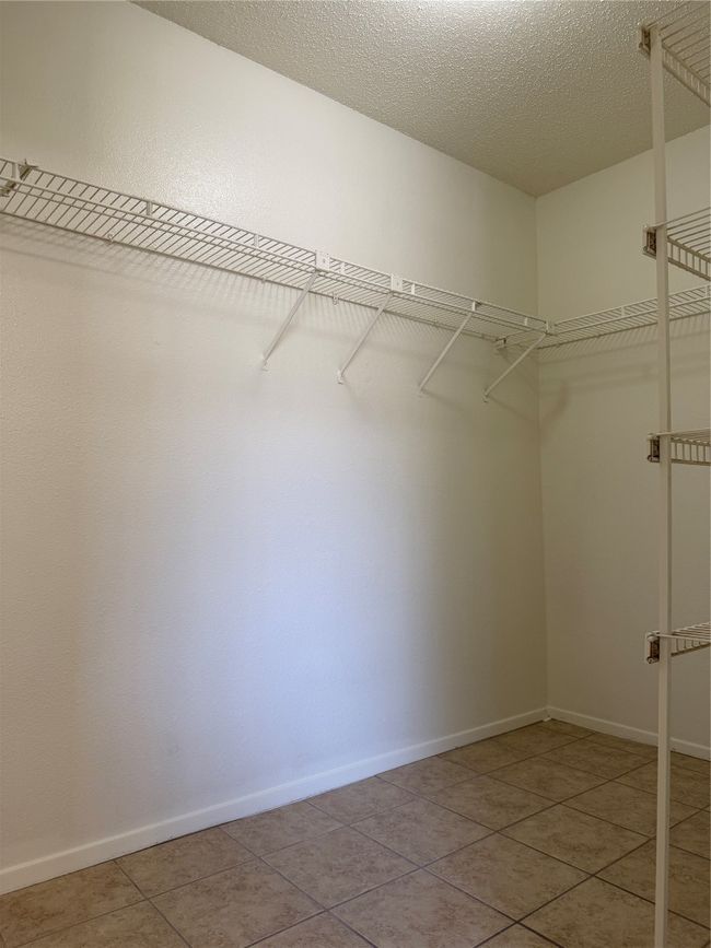 Walk in closet featuring light tile patterned floors | Image 14