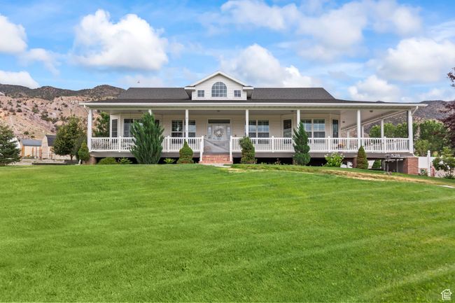 Farmhouse inspired home featuring a front lawn, a mountain view, and roof with shingles | Image 97
