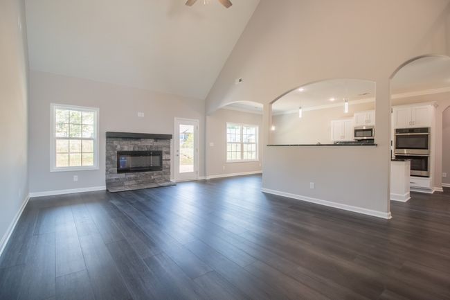 EXAMPLE>>>Spacious Living Room with a Stone Fireplace, Floating Wood Mantle, 2 Story Ceiling and Access to the Large Patio! | Image 5