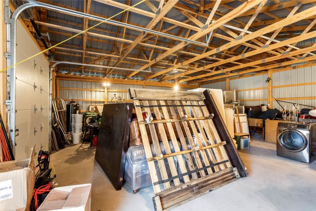 Garage with washer / dryer and metal wall | Image 15