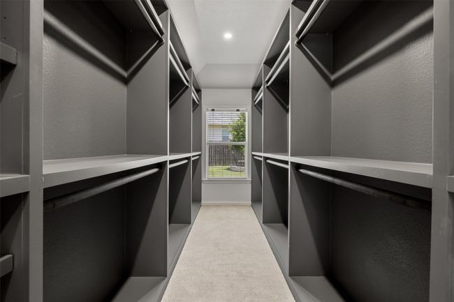 Walk in closet featuring light colored carpet | Image 27