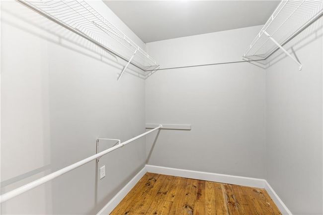 Walk in closet featuring wood finished floors | Image 10