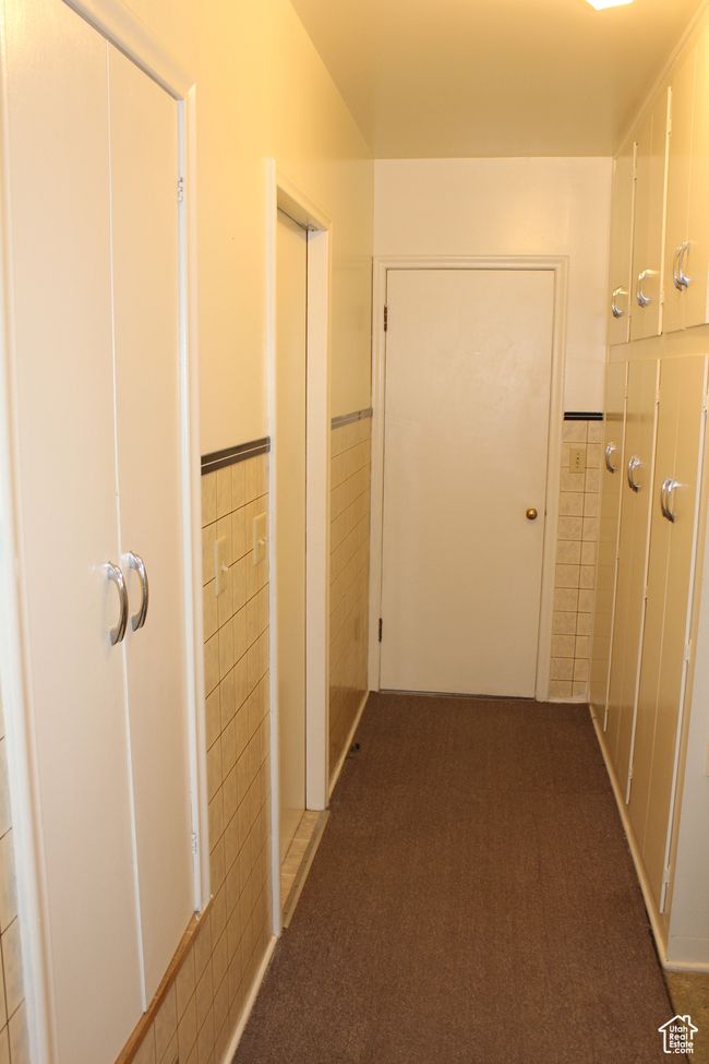 Hall with tile walls, wainscoting, and carpet | Image 35