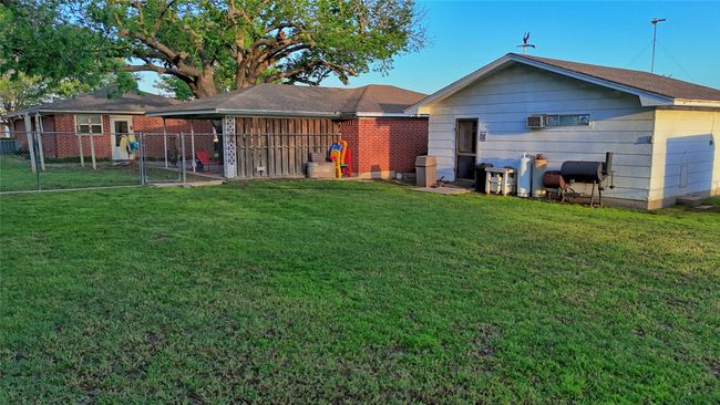 Back of house with fence, a gate, and a yard | Image 20