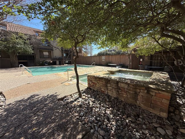 Pool with a hot tub, a patio area, and a fenced backyard | Image 19
