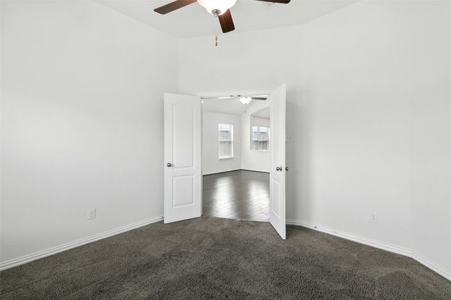 Unfurnished room featuring dark carpet and a ceiling fan | Image 26