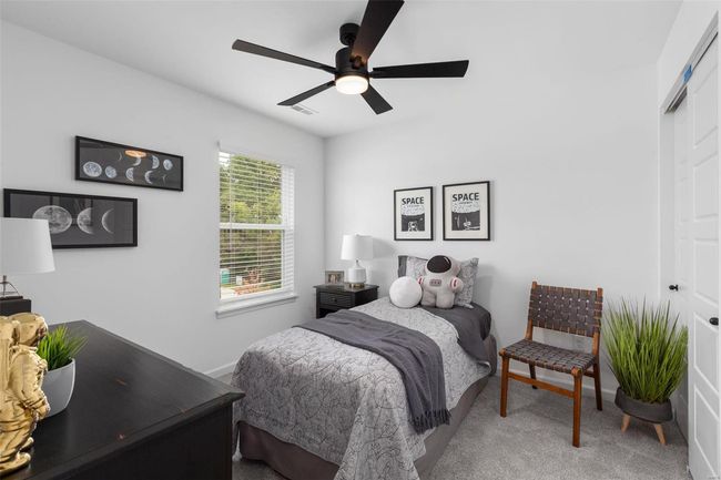 Carpeted bedroom with ceiling fan and a closet | Image 19