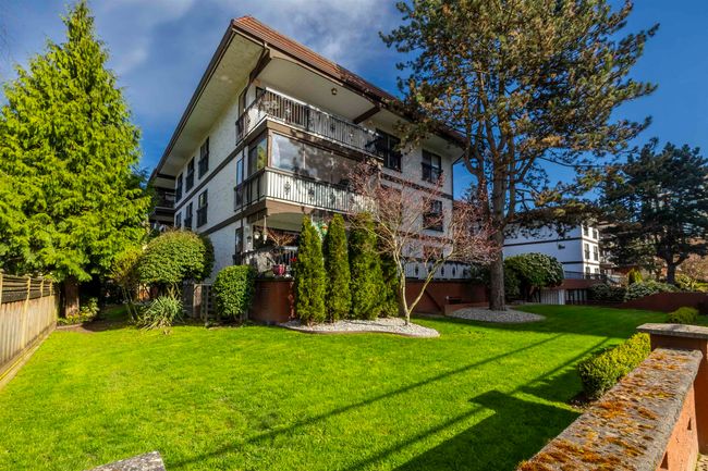 Back of property featuring a balcony, fence, and a lawn | Image 30