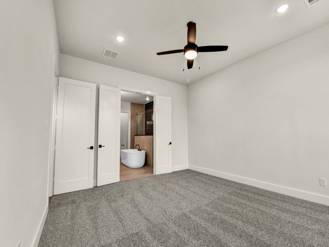 Unfurnished bedroom featuring ensuite bath, ceiling fan, and carpet | Image 19