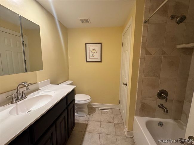 Hall bathroom with ceramic tile flooring and shower walls. | Image 17