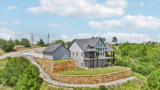 Rear view of property with a yard, roof with shingles, and an outdoor structure | Image 38