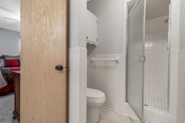 Primary bathroom in a neutral color with gold details | Image 27