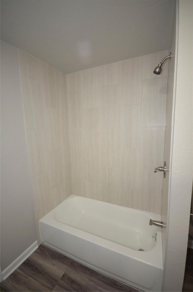 Another view of the beautiful tile work in this hall bathroom | Image 14
