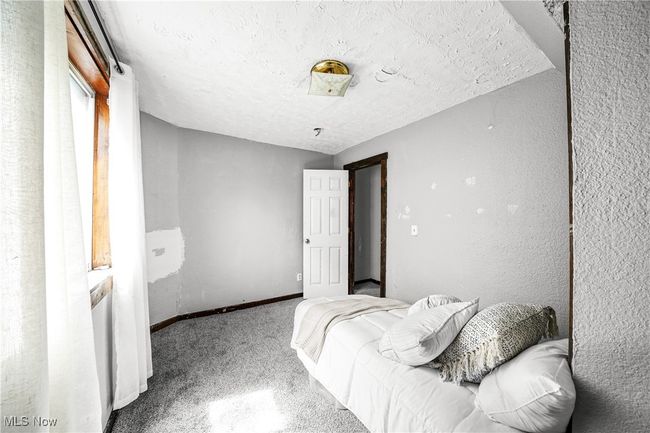 Carpeted bedroom featuring a textured ceiling and baseboards | Image 17