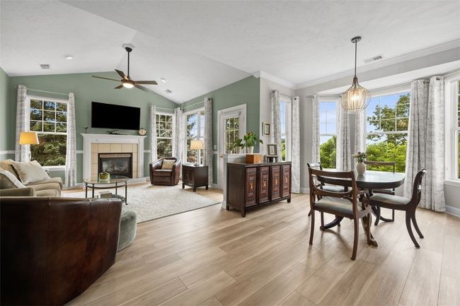 This open concept creates a comfortable living space and the abundance of windows keeps it light and bright year round. | Image 9