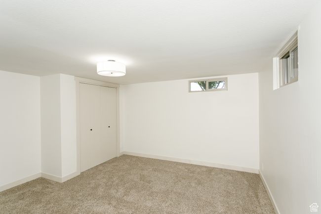 Basement featuring light colored carpet and baseboards | Image 10