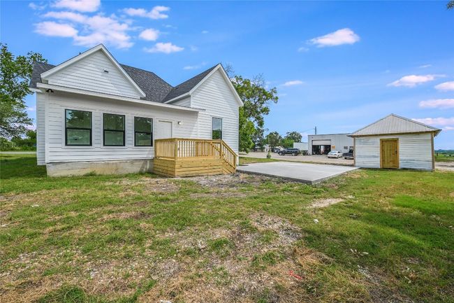 Back of property featuring a yard, roof with shingles, and an outbuilding | Image 4