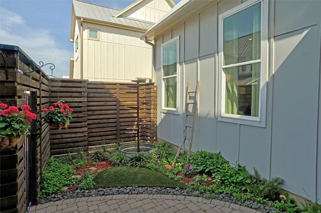 View of side of home with board and batten siding and fence | Image 25