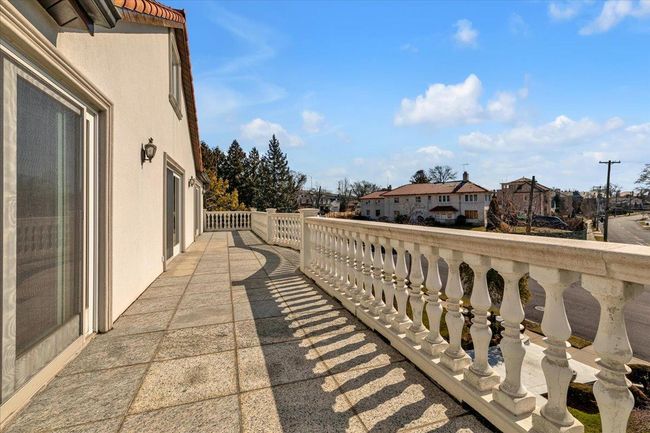 View of patio with a residential view and a balcony | Image 24
